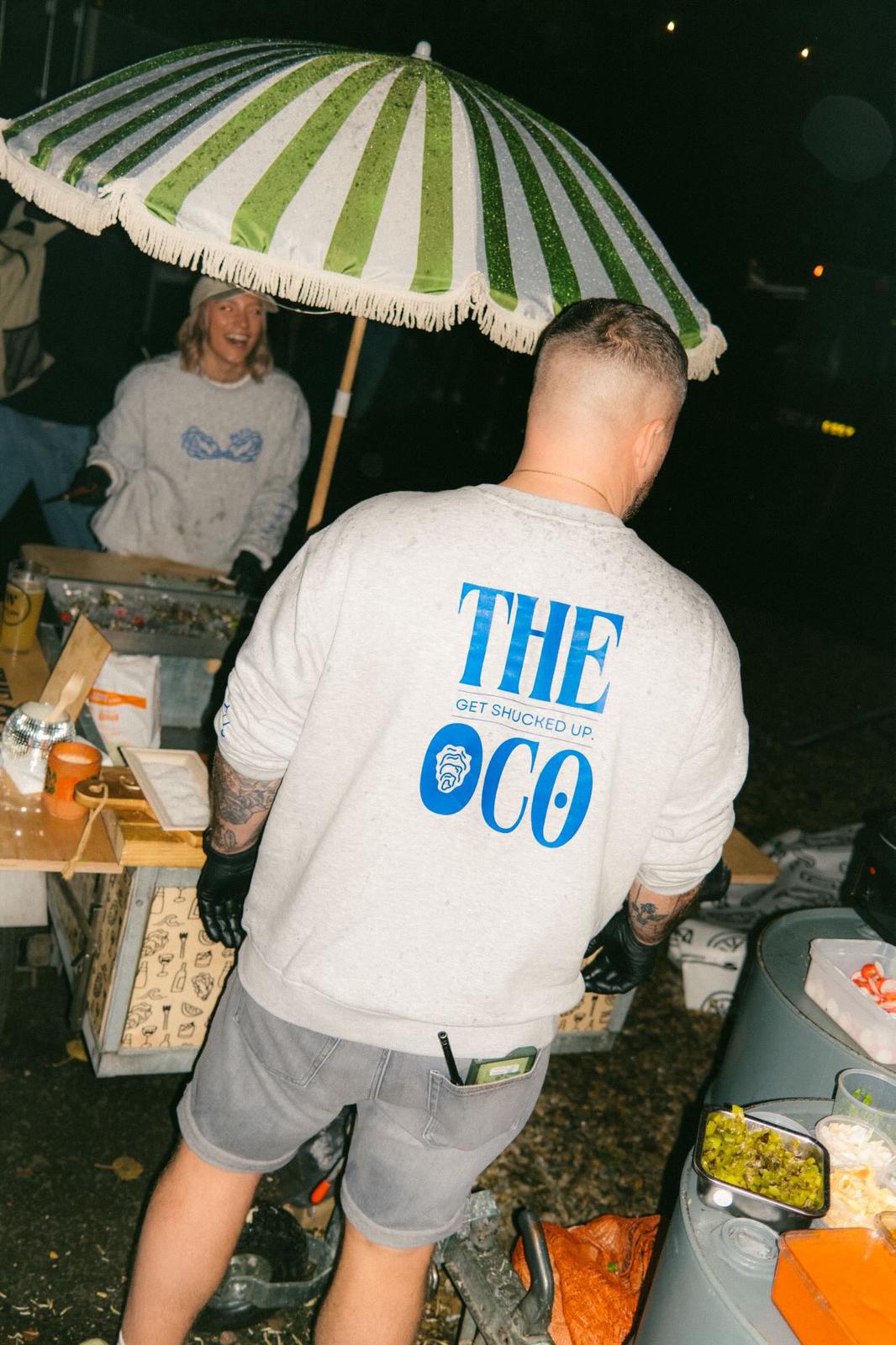 The O Co. branded sweatshirt with 'Get shucked up' graphic