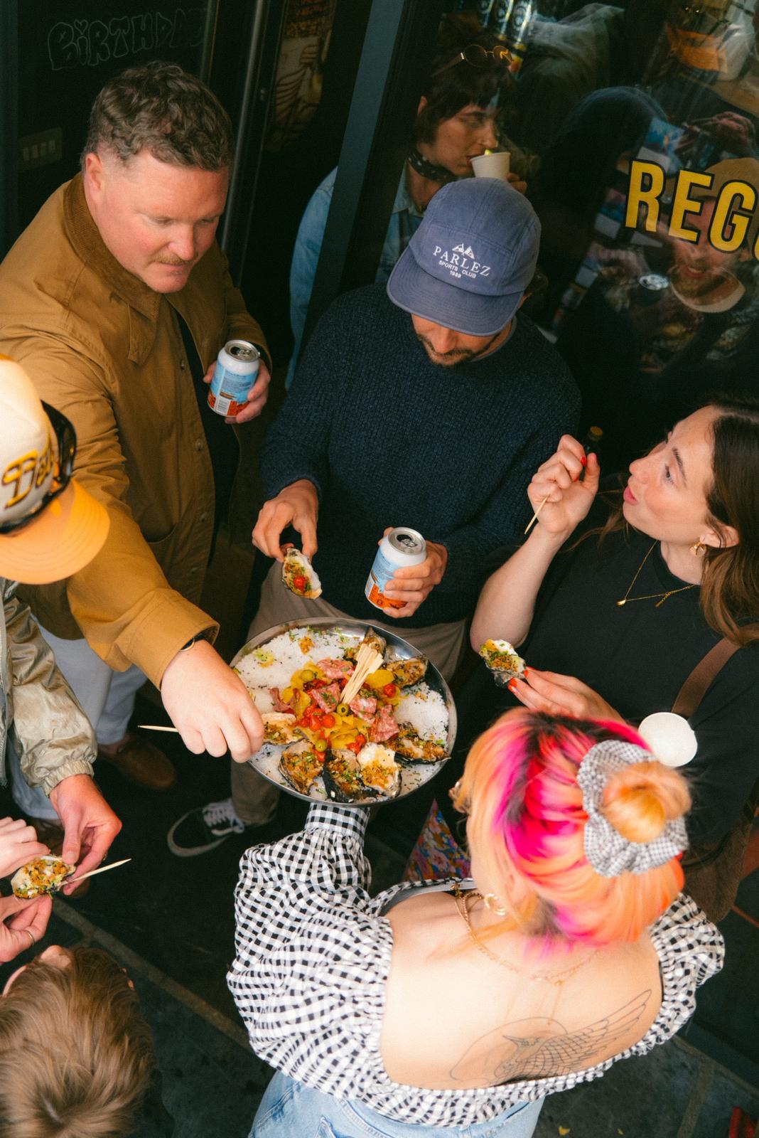 Friends sharing a platter of oysters at a private party